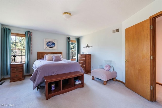 bedroom featuring baseboards, visible vents, and light colored carpet