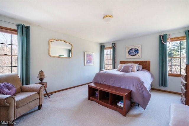carpeted bedroom with baseboards and multiple windows