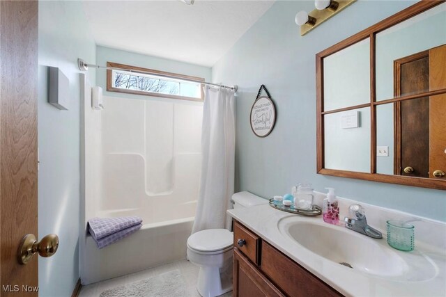 full bathroom with toilet, vanity, and shower / bath combo with shower curtain