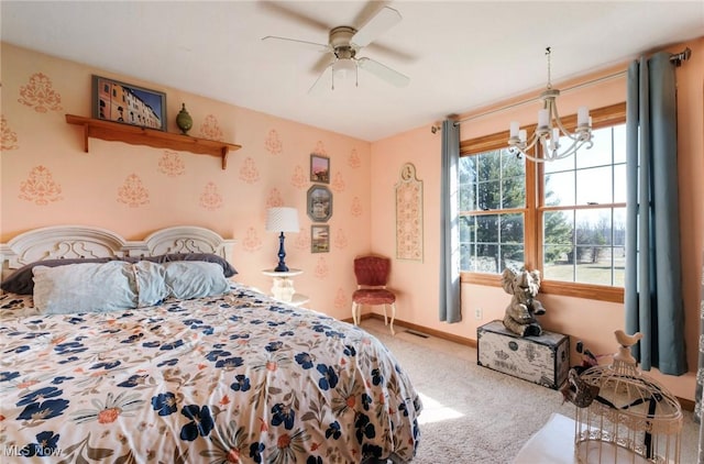 bedroom with ceiling fan with notable chandelier, carpet, and baseboards