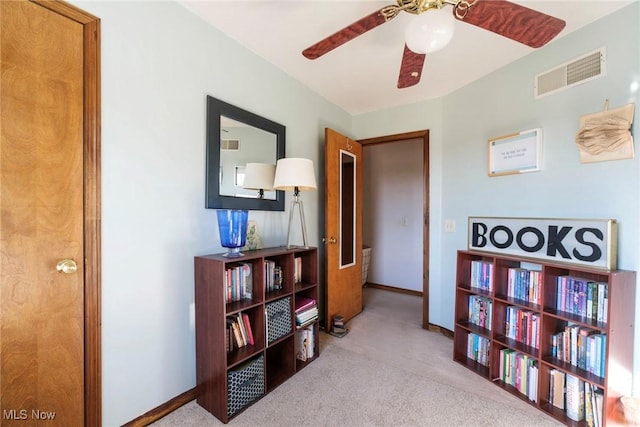 corridor with baseboards, visible vents, and carpet