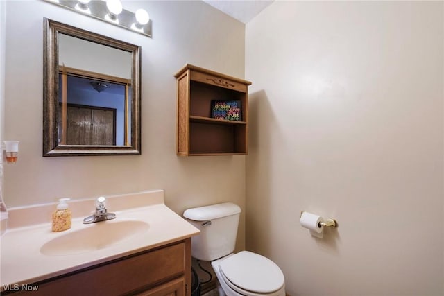 bathroom with toilet and vanity