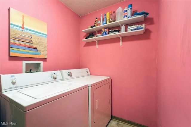 washroom with washing machine and clothes dryer and laundry area