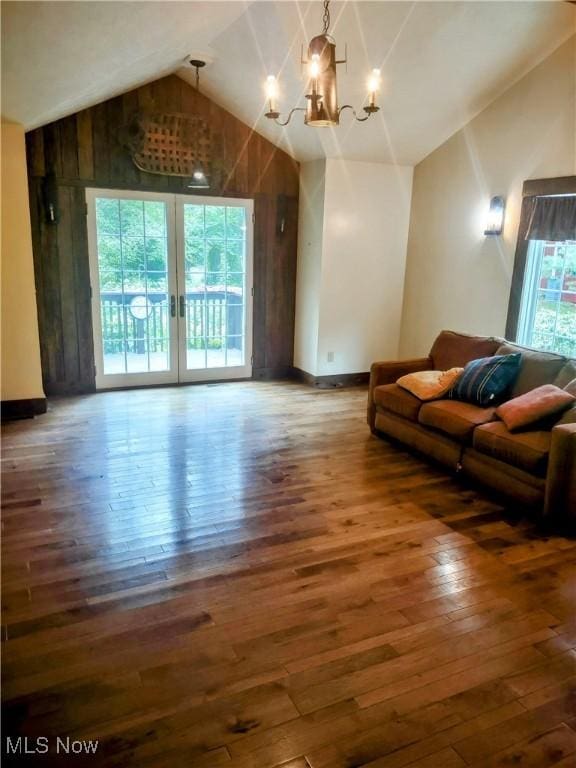 6846 Wakefield, Hiram, OH 44234 - living room featuring vaulted ceiling, hardwood / wood-style flooring, a chandelier, baseboards, and wood walls