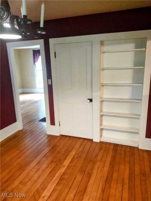 6846 Wakefield, Hiram, OH 44234 - unfurnished bedroom with hardwood / wood-style flooring, baseboards, and a chandelier