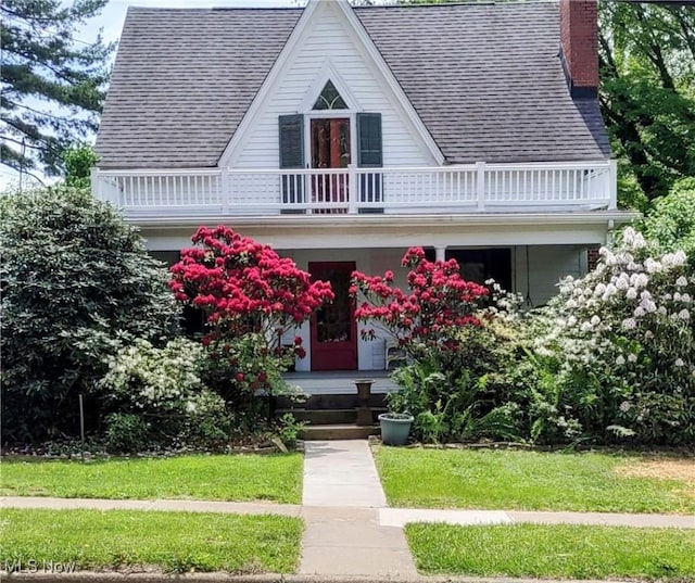 6846 Wakefield, Hiram, OH 44234 - view of front of property featuring a balcony, a chimney, a shingled roof, a porch, and a front yard