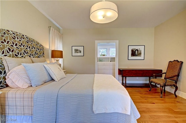 bedroom with baseboards and light wood-type flooring