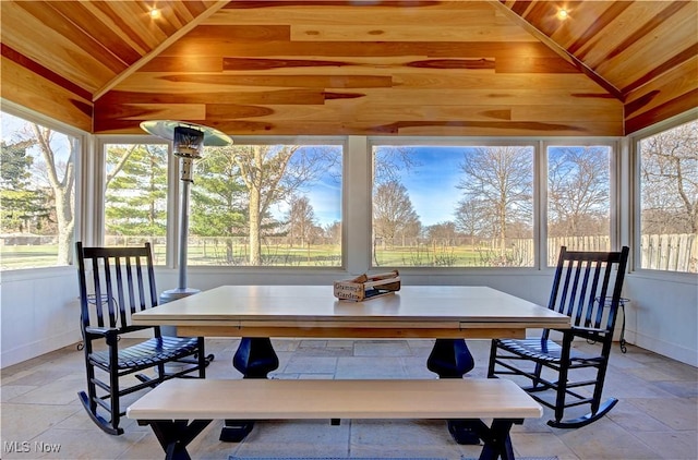 sunroom / solarium with a healthy amount of sunlight, wood ceiling, and lofted ceiling