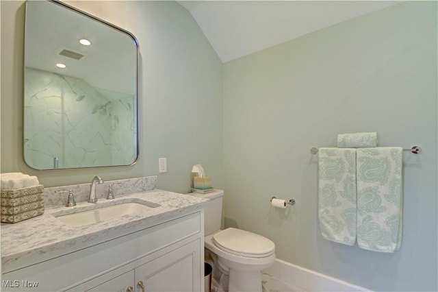 full bath featuring vaulted ceiling, toilet, vanity, a marble finish shower, and baseboards