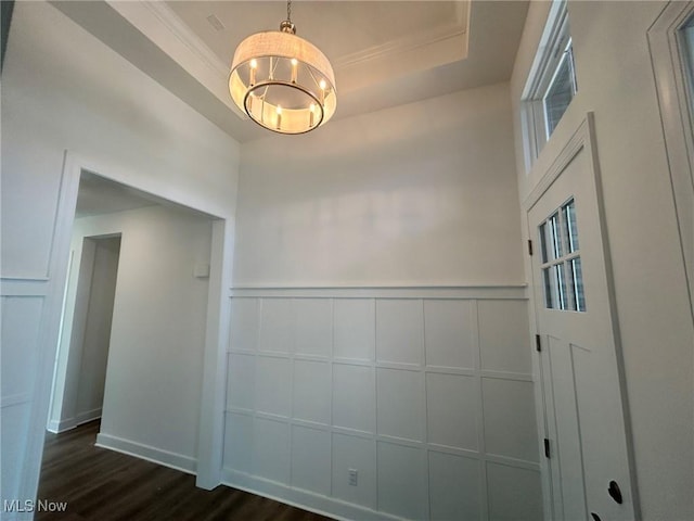 8929 Camden Rd NW, Massillon, OH 44646 - unfurnished room with a decorative wall, dark wood-type flooring, a tray ceiling, ornamental molding, and a chandelier