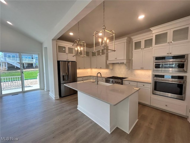 8929 Camden Rd NW, Massillon, OH 44646 - kitchen with appliances with stainless steel finishes, a sink, a chandelier, backsplash, and vaulted ceiling