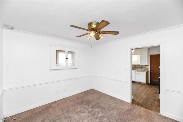 3716 E 52nd St, Cleveland, OH 44105 - empty room with baseboards, dark carpet, ornamental molding, and a ceiling fan