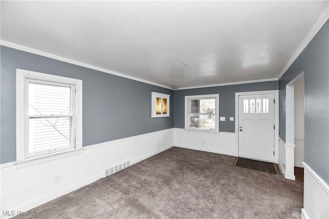 3716 E 52nd St, Cleveland, OH 44105 - entryway featuring visible vents, crown molding, and dark colored carpet
