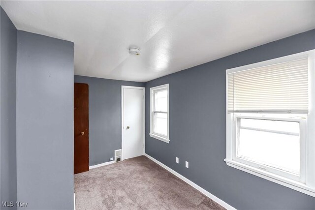 3716 E 52nd St, Cleveland, OH 44105 - spare room with baseboards and carpet floors