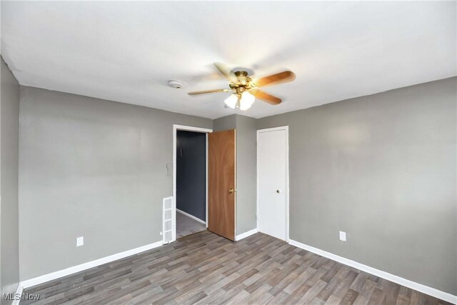 3716 E 52nd St, Cleveland, OH 44105 - unfurnished room with wood finished floors, baseboards, and ceiling fan