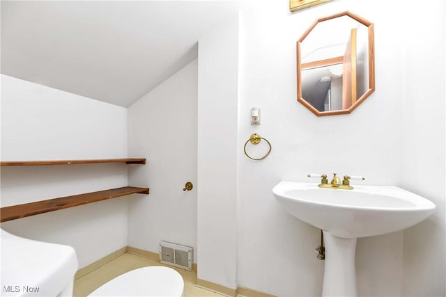 3716 E 52nd St, Cleveland, OH 44105 - half bath featuring vaulted ceiling, visible vents, and toilet