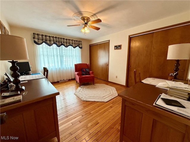 office featuring light wood-style floors and a ceiling fan