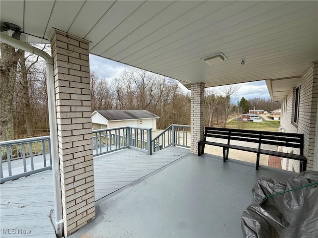 view of patio with an outdoor structure and a deck