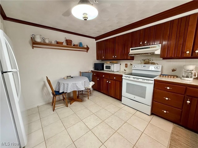 kitchen with tile counters, white appliances, ornamental molding, under cabinet range hood, and backsplash