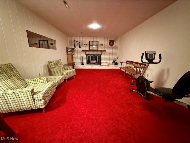 sitting room with carpet floors and a brick fireplace