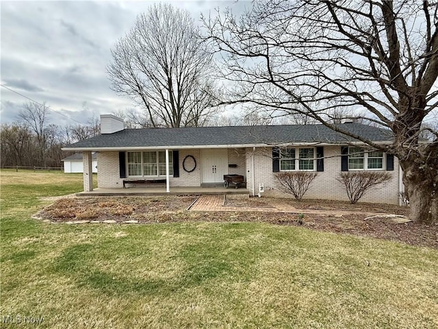 single story home with brick siding, a chimney, and a front lawn