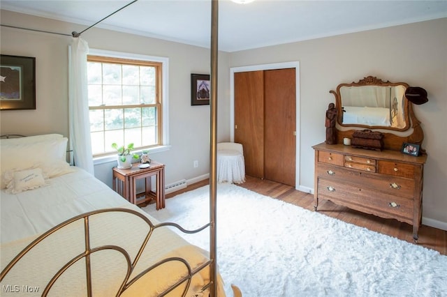 bedroom featuring a closet, baseboards, and light wood-style floors