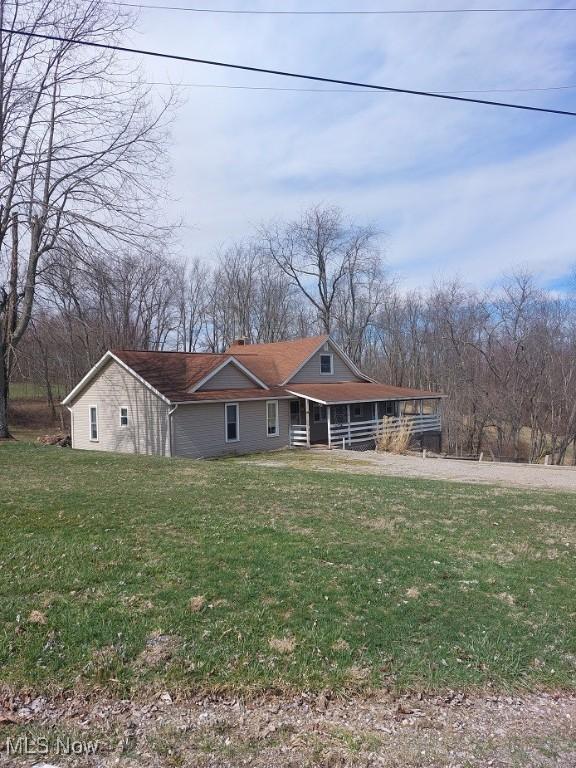 87478 Sinfield Rd, Hopedale, OH 43976 - view of front facade featuring a chimney, a porch, and a front yard