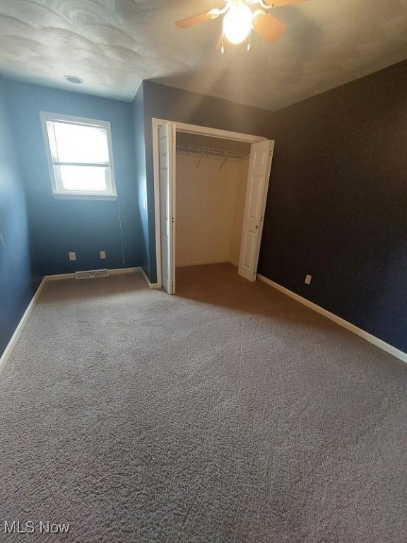 87478 Sinfield Rd, Hopedale, OH 43976 - unfurnished bedroom featuring baseboards, carpet floors, ceiling fan, visible vents, and a closet