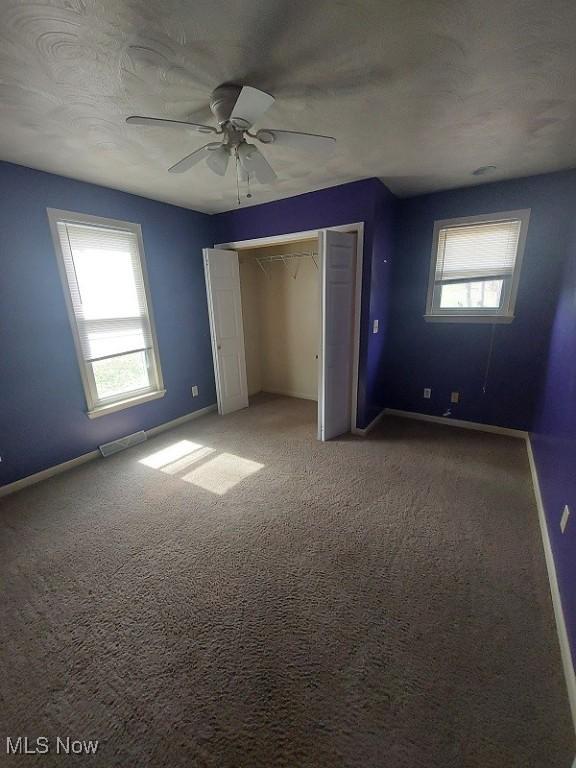 87478 Sinfield Rd, Hopedale, OH 43976 - unfurnished bedroom with baseboards, visible vents, a closet, and carpet flooring