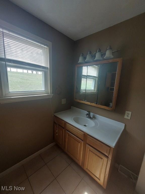 87478 Sinfield Rd, Hopedale, OH 43976 - bathroom with baseboards, a healthy amount of sunlight, tile patterned floors, and vanity