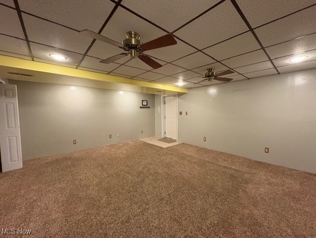 finished basement with carpet and a paneled ceiling