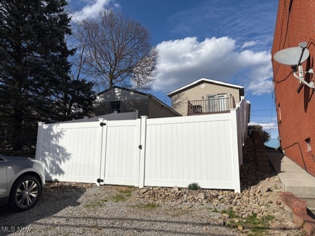 view of side of home with fence