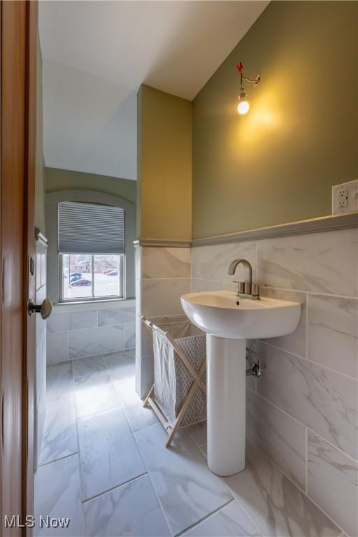 203 W 6th St, Dover, OH 44622 - bathroom featuring marble finish floor, a wainscoted wall, and tile walls