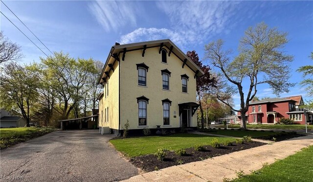 203 W 6th St, Dover, OH 44622 - italianate-style house with a front lawn, driveway, and a carport