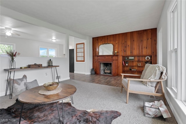 507 Beacon Rd, Newark, OH 43055 - living room featuring carpet flooring, plenty of natural light, ceiling fan, wood walls, and a fireplace