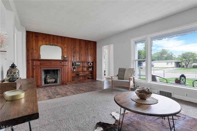 507 Beacon Rd, Newark, OH 43055 - living area with wooden walls, carpet flooring, a fireplace with flush hearth, and baseboards
