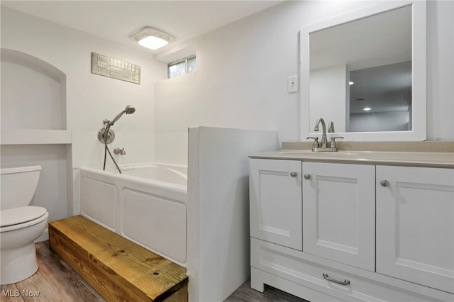 507 Beacon Rd, Newark, OH 43055 - full bathroom with toilet, a garden tub, vanity, and wood finished floors