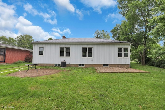 507 Beacon Rd, Newark, OH 43055 - back of property with a lawn, metal roof, cooling unit, and a chimney