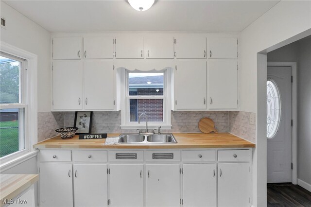 507 Beacon Rd, Newark, OH 43055 - kitchen featuring a sink, white cabinetry, and decorative backsplash