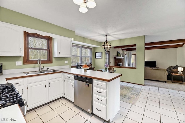 21242 Jonathan Dr, Strongsville, OH 44149 - kitchen featuring gas stove, stainless steel dishwasher, a sink, white cabinets, and a peninsula