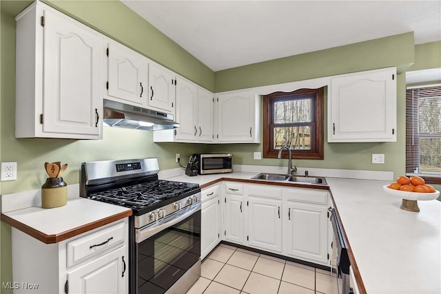 21242 Jonathan Dr, Strongsville, OH 44149 - kitchen with appliances with stainless steel finishes, under cabinet range hood, white cabinetry, a sink, and a healthy amount of sunlight