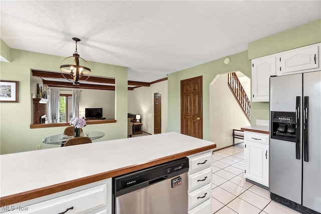 21242 Jonathan Dr, Strongsville, OH 44149 - kitchen featuring light tile patterned flooring, light countertops, pendant lighting, white cabinetry, and appliances with stainless steel finishes