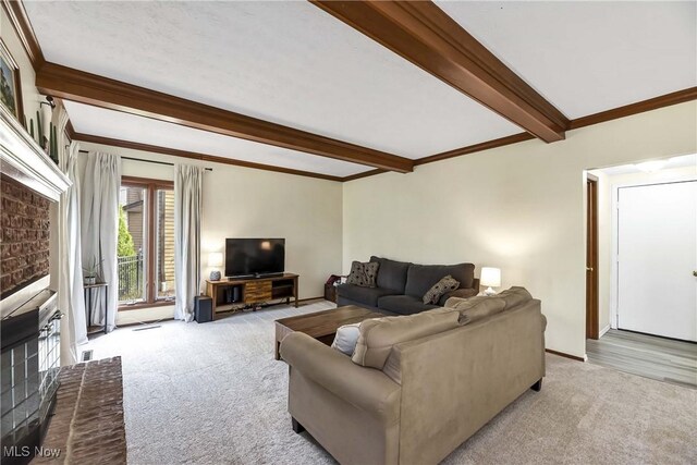 21242 Jonathan Dr, Strongsville, OH 44149 - carpeted living area featuring a fireplace, crown molding, and beam ceiling