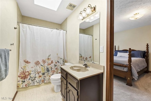 21242 Jonathan Dr, Strongsville, OH 44149 - full bathroom featuring vanity, toilet, connected bathroom, a skylight, and visible vents
