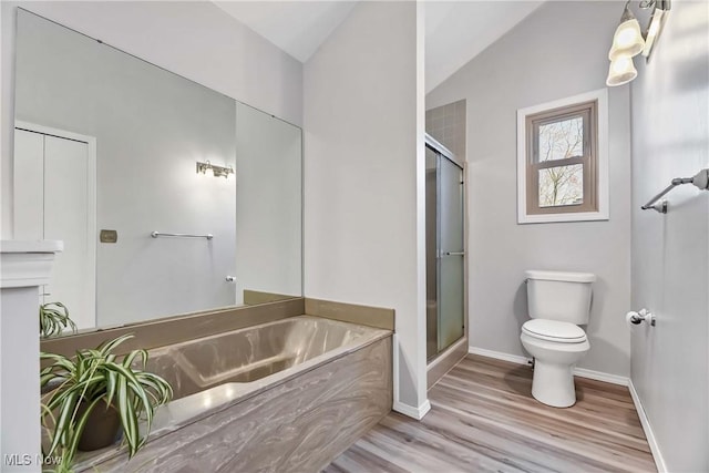21242 Jonathan Dr, Strongsville, OH 44149 - bathroom with vaulted ceiling, toilet, a shower stall, a garden tub, and wood finished floors
