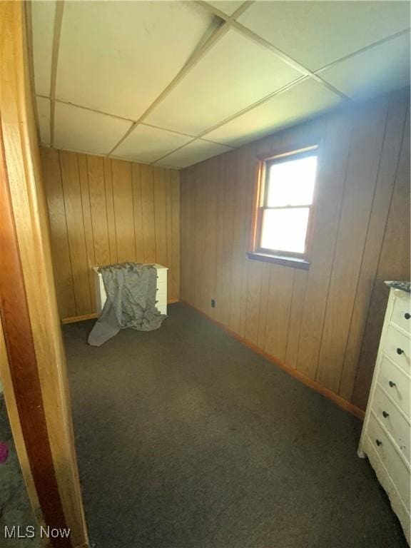 515 E Sixth St, East Liverpool, OH 43920 - unfurnished bedroom featuring carpet floors, wood walls, and a drop ceiling