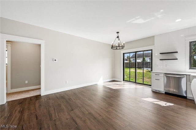 260 Michaels Ct, Cortland, OH 44410 - unfurnished living room with dark wood-type flooring, a chandelier, and baseboards