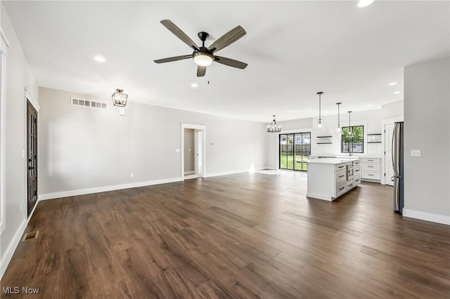 260 Michaels Ct, Cortland, OH 44410 - unfurnished living room with a ceiling fan, recessed lighting, dark wood-type flooring, a chandelier, and baseboards