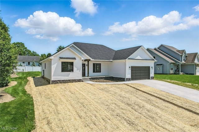 260 Michaels Ct, Cortland, OH 44410 - modern farmhouse featuring a garage, concrete driveway, and board and batten siding