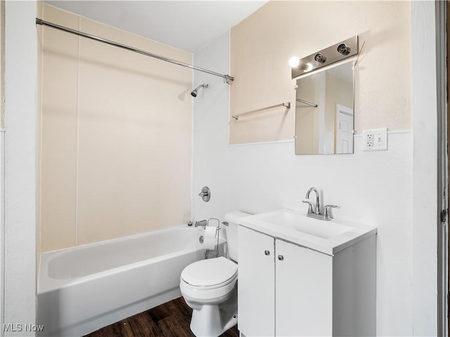 full bathroom featuring shower / washtub combination, wood finished floors, toilet, and vanity